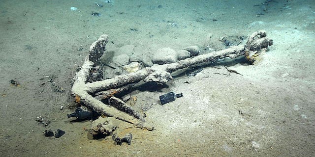 This image taken by NOAA Ocean Exploration in February 2022 shows what researchers believe to be the wreck of the only whaling ship known to have sunk in the Gulf of Mexico. The two-masted brig Industry went down in 1836 about 70 miles from the mouth of the Mississippi River. An anchor and bottles believed to date to the early 1800s are visible. (NOAA Ocean Exploration via AP)