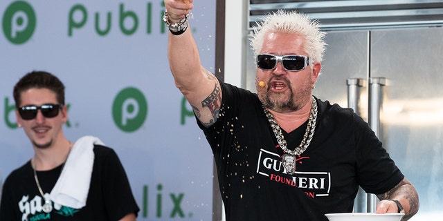 Hunter Fieri, left, and Guy Fieri perform a cooking demo onstage at the Grand Tasting Village during the 2022 South Beach Wine And Food Festival on Feb. 26, 2022 in Miami Beach, Florida. 