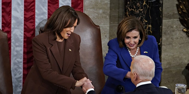 President Biden greets Vice President Kamala Harris, left, and House Speaker Nancy Pelosi after delivering his State of the Union address at the U.S. Capitol in Washington, D.C., March 1, 2022. Harris wore an all-brown suit during the president's speech. 