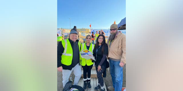 Utah restaurateur Dirk Astle (first on the left) took time off from his work to hand-deliver letters and essential relief goods to refugees at the Poland-Ukraine border.