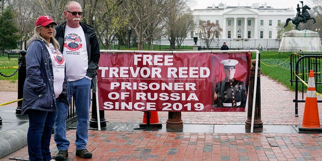 Joey and Paula Reed, parents of U.S. Marine Corps veteran and Russian prisoner Trevor Reed, stand in Lafayette Park near the White House, Wednesday, March 30, 2022, in Washington. 