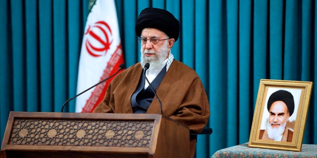 In this photo published by the official website of the office of the Iranian Supreme Leader, Supreme Leader Ayatollah Ali Khamenei speaks in a televised New Year's speech, in Tehran, Iran, on Monday 21 March 2022. Khamenei signaled support for the Tehran nuclear negotiations for sure relief from sanctions, a rare reference to talks still interrupted as world powers are close to a diplomatic breakthrough.  A portrait of the late Iranian revolutionary founder, Ayatollah Khomeini, is shown on the right. 