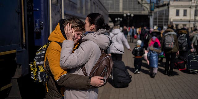 A mother embraces her son who escaped the besieged city of Mariupol and arrived at the train station in Lviv, western Ukraine on Sunday, March 20, 2022.