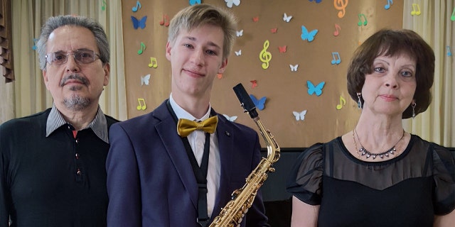 Matthew Frantsuzhan, a choir member, saxophone player and piano player, is shown here with two of his music teachers. He studied music in Ukraine for eight years before arriving in the U.S. as an exchange student.