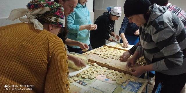 Women in Ukrainian Village of Vykoty making dumplings for Ukrainian forces.