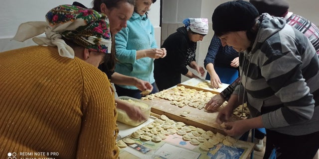 Women in Ukrainian Village of Vykoty making dumplings for Ukrainian forces.