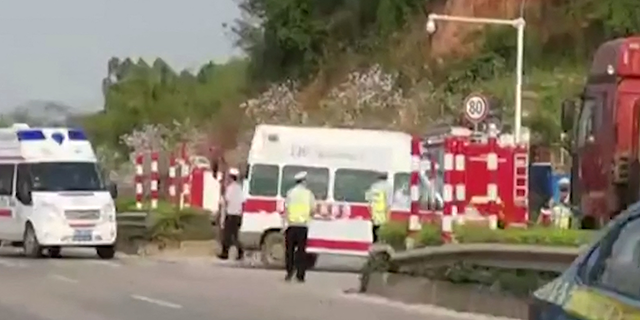 This screen grab taken from video from The Paper and received via AFPTV on March 21, 2022 shows ambulances turning off onto a side road upon arrival after a China Eastern reportedly crashed in Teng County in Wuzhou City, Guangxi province. - The China Eastern passenger jet carrying 132 people "crashed" in southwest China, the state flight regulator confirmed on March 21, with the number of casualties unknown according to the country's state broadcaster.