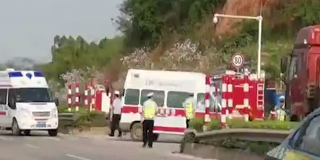 This screen grab taken from video from The Paper and received via AFPTV on March 21, 2022 shows ambulances turning off onto a side road upon arrival after a China Eastern reportedly crashed in Teng County in Wuzhou City, Guangxi province. - The China Eastern passenger jet carrying 132 people "crashed" in southwest China, the state flight regulator confirmed on March 21, with the number of casualties unknown according to the country's state broadcaster.