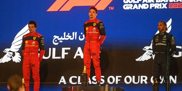 KFC burns Mercedes F1 team with Kentucky fried tweet 3 Ferrari's Spanish driver Carlos Sainz Jr (L), Ferrari's Monegasque driver Charles Leclerc (C) and Mercedes' British driver Lewis Hamilton stand for the national anthem on the podium after the Bahrain Formula One Grand Prix at the Bahrain International Circuit in the city of Sakhir on March 20, 2022. (Photo by OZAN KOSE / AFP) (Photo by OZAN KOSE/AFP via Getty Images)
