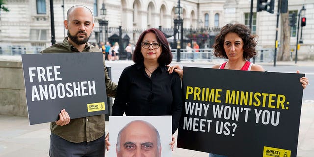 Aryan Ashoori, Sherry Izadi and Elika Ashoori, the son, wife and daughter of Anoosheh Ashoori, staged a protest opposite Downing Street, London, on Aug. 13, 2021, on the fourth anniversary of his imprisonment.