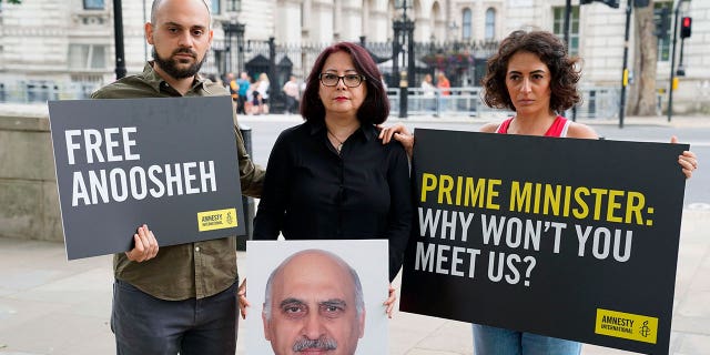 Aryan Ashoori, Sherry Izadi and Elika Ashoori, the son, wife and daughter of Anoosheh Ashoori, staged a protest opposite Downing Street, London, on Aug. 13, 2021, on the fourth anniversary of his imprisonment.