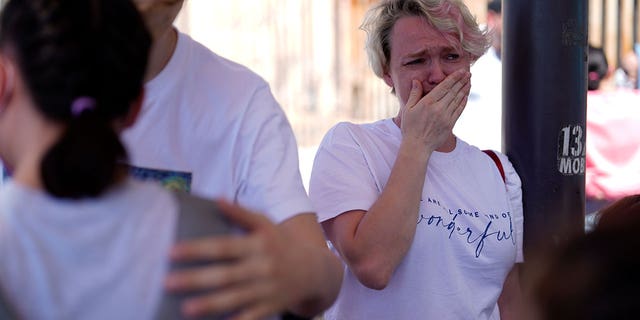 Irina Zolinka, who is seeking asylum in the U.S., cries near the San Ysidro Port of Entry into the United States, in Tijuana, Mexico, Thursday, March 17, 2022.