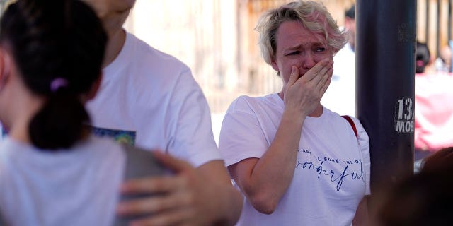 Irina Zolinka, who is seeking asylum in the U.S., cries near the San Ysidro Port of Entry into the United States, in Tijuana, Mexico, Thursday, March 17, 2022.