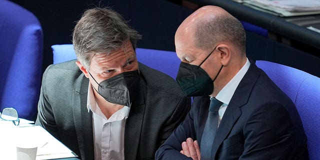 German Economy and Climate Minister Robert Habeck, left, and Chancellor Olaf Scholz attend a budget debate at the German federal parliament, Bundestag, in Berlin, Wednesday, March 23, 2022.