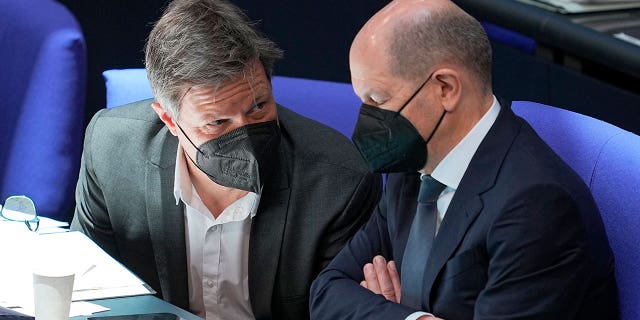 German Economy and Climate Minister Robert Habeck, left, and Chancellor Olaf Scholz attend a budget debate at the German federal parliament, Bundestag, in Berlin, Wednesday, March 23, 2022.