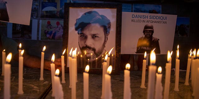 In this July 17, 2021, file photo, journalists in New Delhi, India, light candles and pay tribute to Reuters photographer Danish Siddiqui, who was killed in Afghanistan covering clashes between the Taliban and Afghan security forces. 