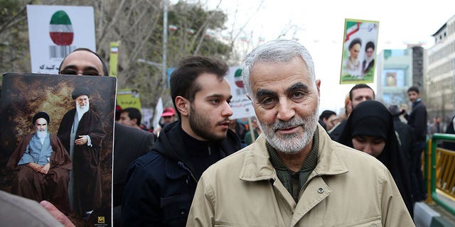 Soleimani walks with a crowd