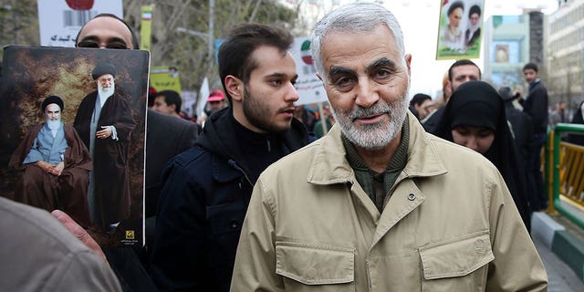 Soleimani walks with a crowd