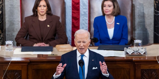 President Joe Biden delivers his first State of the Union address to a joint session of Congress at the Capitol, Tuesday, March 1, 2022, in Washington as Vice President Kamala Harris and House speaker Nancy Pelosi of Calif., look on.