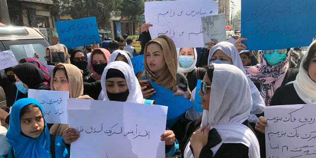 Afghan women chanting and hold signs of protest during a demonstration in Kabul, Afghanistan, March 26.