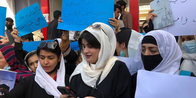 Afghan women chant and hold signs to protest during a demonstration in Kabul, Afghanistan, Saturday, March 26, 2022. 