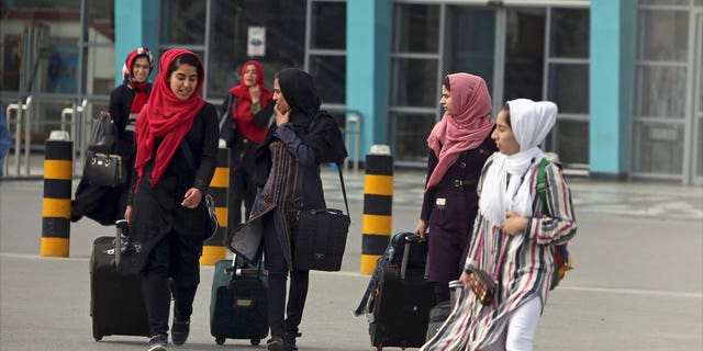 Members of a female robotics team arrive from Herat province to receive visas from the U.S. embassy at the Hamid Karzai International Airport in Kabul, Afghanistan, July 13, 2017. Afghanistan's Taliban rulers refused to allow dozens of women to board several flights, including some overseas, because they were traveling without a male guardian, two Afghan airline officials said Saturday, March 26, 2022.  