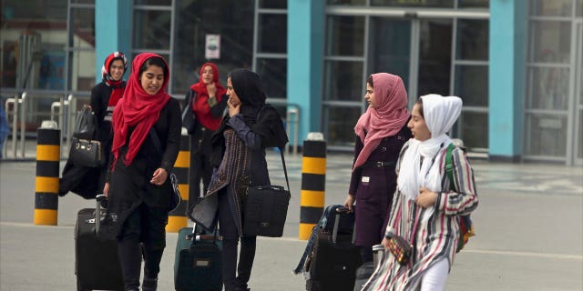 Members of a female robotics team arrive from Herat province to receive visas from the U.S. embassy at the Hamid Karzai International Airport in Kabul, Afghanistan, July 13, 2017. Afghanistan's Taliban rulers refused to allow dozens of women to board several flights, including some overseas, because they were traveling without a male guardian, two Afghan airline officials said Saturday, March 26, 2022.