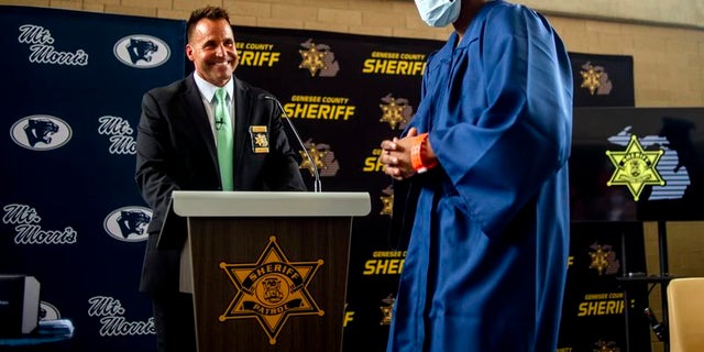 Sheriff Chris Swanson attends graduation ceremony.