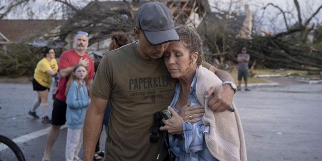 Michael Talamantez comforts his girlfriend Derry Schroer after Talamantez' house on Stratford Drive in Round Rock, Texas, was destroyed by a severe storm while they were inside on Monday March 21, 2022. "I thought I was going to die," he said.