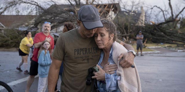 Michael Talamantez comforts his girlfriend Derry Schroer after Talamantez' house on Stratford Drive in Round Rock, Texas, was destroyed by a severe storm while they were inside on Monday March 21, 2022. "I thought I was going to die," he said.