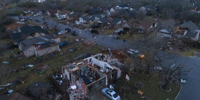 Debris litters the ground surrounding homes damaged by severe storms in Round Rock, Texas Monday March 21, 2022.