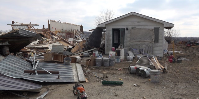 A storage structure sustains damage after a tornado hit over 13 miles in Winterset, Iowa. 