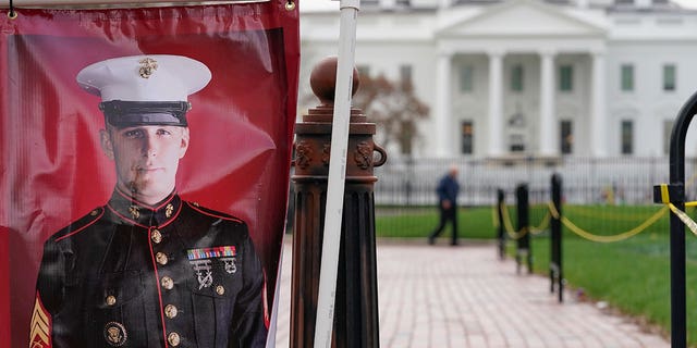 A poster photo of U.S. Marine Corps veteran and Russian prisoner Trevor Reed stands in Lafayette Park near the White House, Wednesday, March 30, 2022, in Washington. 