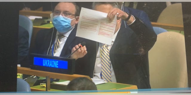 Ukraine's U.N. Ambassador Sergiy Kyslytsya holds up what he says is the South African-sponsored Ukraine humanitarian U.N. General Assembly draft resolution that was never voted on Thursday due to a procedural challenge. Kyslytsya held it up to illustrate how similar it was to Russia's Security Council humanitarian draft resolution that failed Wednesday.