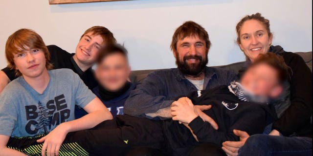Tracy Blake-Bell and Nat Bell, their two biological children and the two Ukrainian children they hope to adopt. For the safety of the children and the adoption process, the adoptive parents cannot reveal their names or faces.