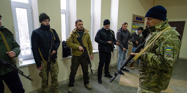 An instructor discusses urban combat as Ukrainian civilians undergo basic military training at a volunteer center in a state educational institution, before an expected Russian assault on March 5, 2022, in Odessa, Ukraine. 