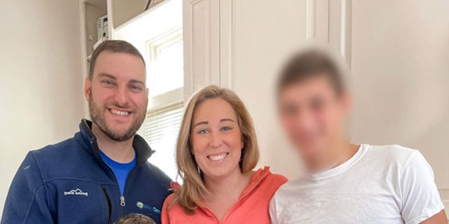Jennifer and Matthew Ruff with the Ukrainian boy they hope to adopt. For the safety of the child and the adoption process, the adoptive parents cannot reveal his name or face. 