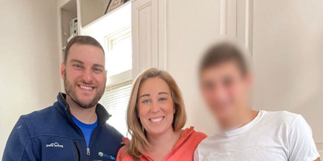 Jennifer and Matthew Ruff with the Ukrainian boy they hope to adopt. For the safety of the child and the adoption process, the adoptive parents cannot reveal his name or face.