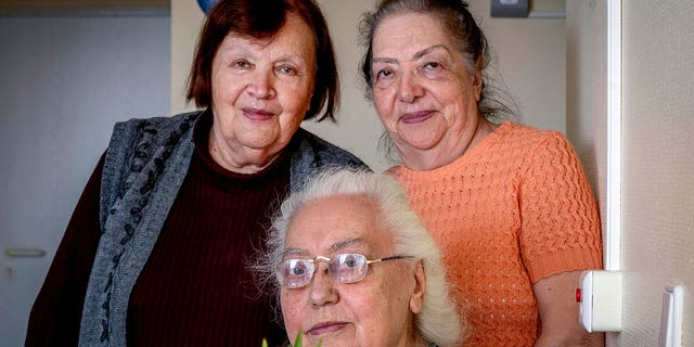 Ukrainian Holocaust survivors Tatyana Zhuravliova, right, Larisa Dzuenko, left, and Galina Ulyanova pose for a photo during an AP interview in an old people's home in Frankfurt, Germany, Sunday, March 27, 2022. 