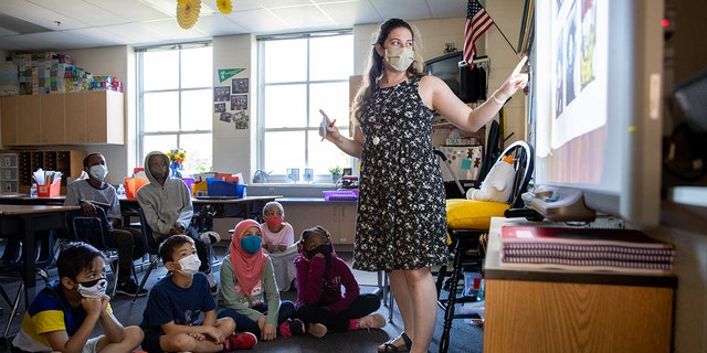 Gabby Mondelli teaches her fourth grade students at Samuel W. Tucker Elementary School in Alexandria, Virginia, on Thursday, August 19, 2021. The Alexandria City Public School district  has mandated that everyone wears masks indoors, regardless of vaccination status.