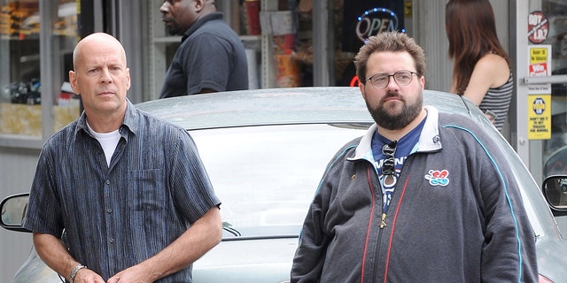 Kevin Smith (right) apologized to Bruce Willis on Wednesday for his past complaints about working with the actor on "Cop Out."