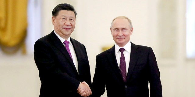 Russian President Vladimir Putin shakes hands with his Chinese counterpart Xi Jinping at the Kremlin in Moscow, June 5, 2019.