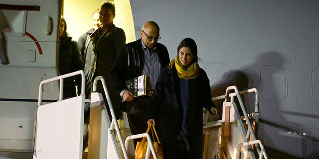 Nazanin Zaghari-Ratcliffe and Anoosheh Ashoori disembark from a plane at Brize Norton air base in England Thursday, March 17, 2022.