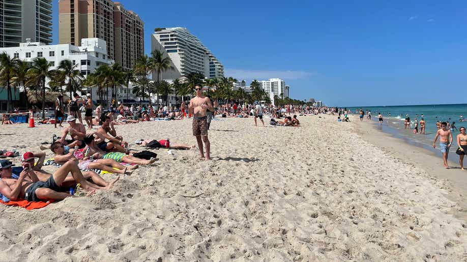 Kyle, who studies environmental economics at the University of Maryland, poses on the beach across from Las Olas Boulevard in Fort Lauderdale.