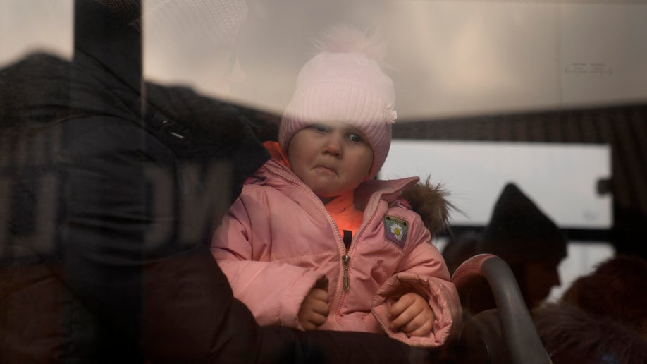 baby peers out train window russian-ukraine war