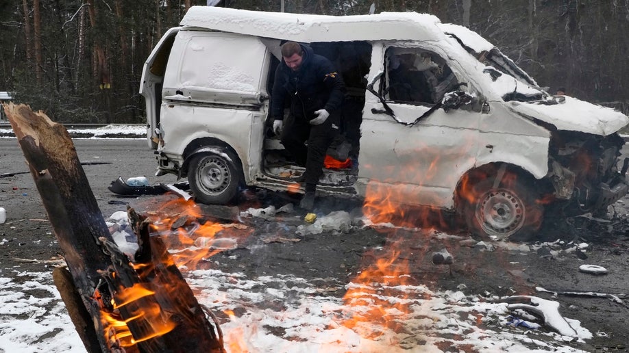 A man leaves a vehicle damaged by shelling in Brovary, outside Kyiv, Ukraine, Tuesday, March 1, 2022. 