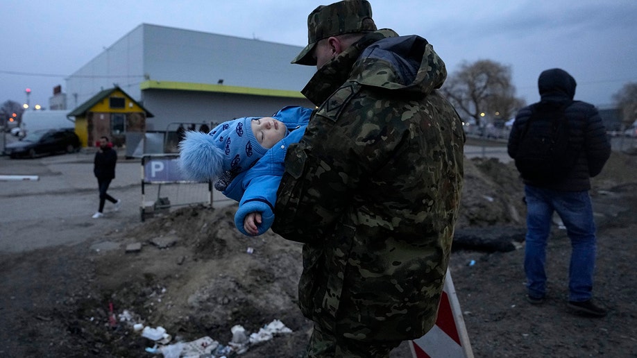 A Polish soldier with a Ukrainian refugee