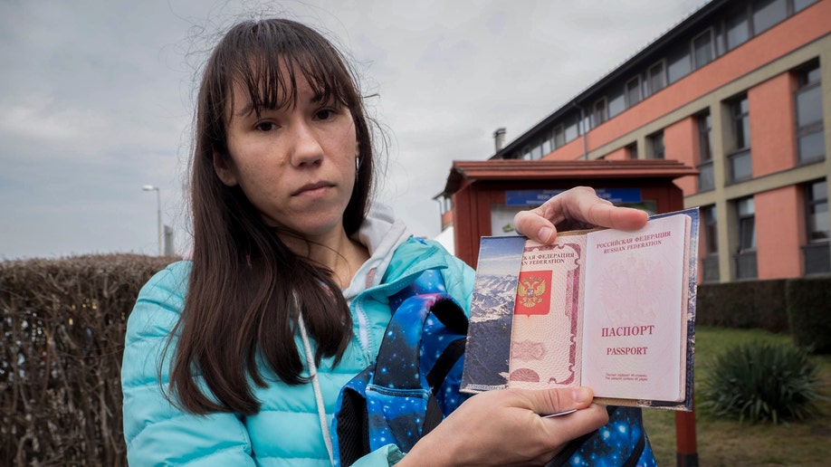Olena, a Russian citizen fleeing from Kyiv, Ukraine (no family name given for safety reson) shows her Russian passport after arriving at the outskirt of Budapest, Hungary on Friday, March. 4, 2022. Leonid Nevzlin, a Russian-born oligarch, on Tuesday said he was renouncing his Russian citizenship over the war. 