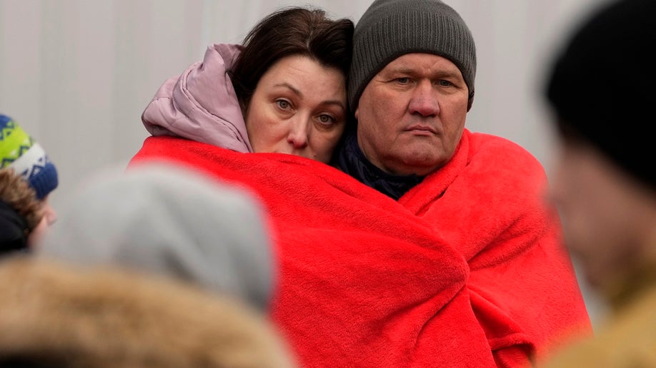 Ukrainian refugees in blankets