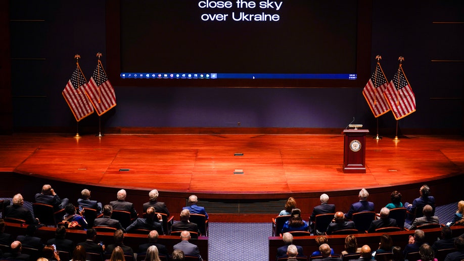 The words "close the sky over Ukraine" are displayed as Ukrainian President Volodymyr Zelenskyy speaks to the U.S. Congress at the Capitol in Washington, Wednesday, March 16, 2022. 